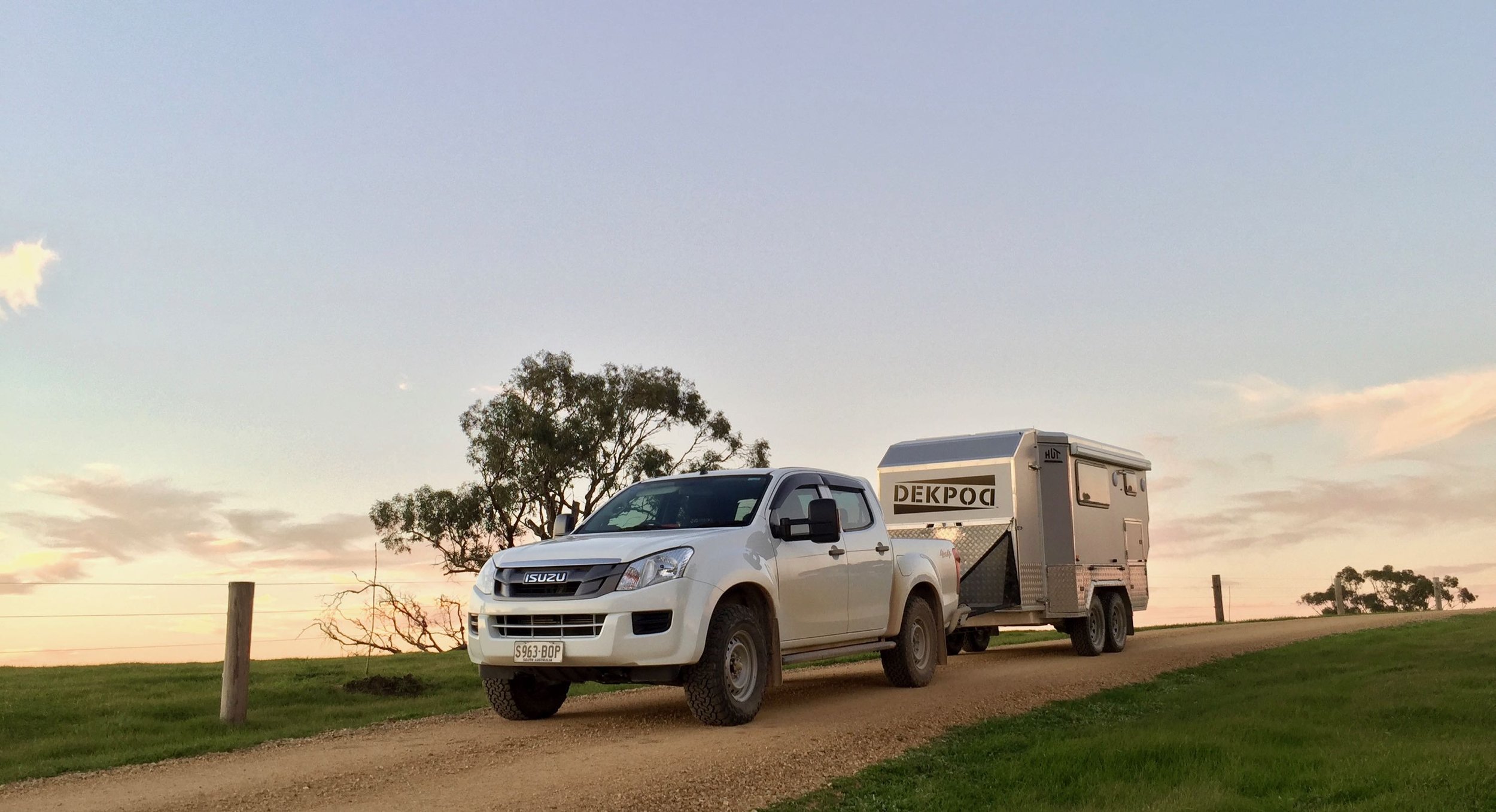 A vehicle on a hill with the HUTrv DEKPOD prototype attached. The sun is setting in the background.